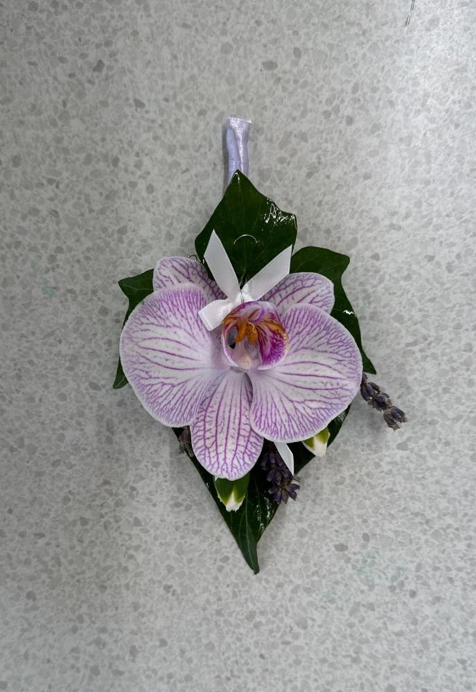 Ladies pinned corsage with fresh orchid and dried lavender